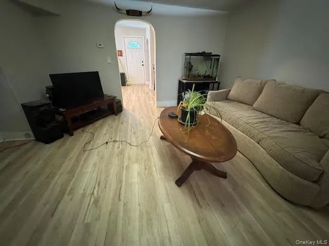 a living room with a couch and a wooden floor