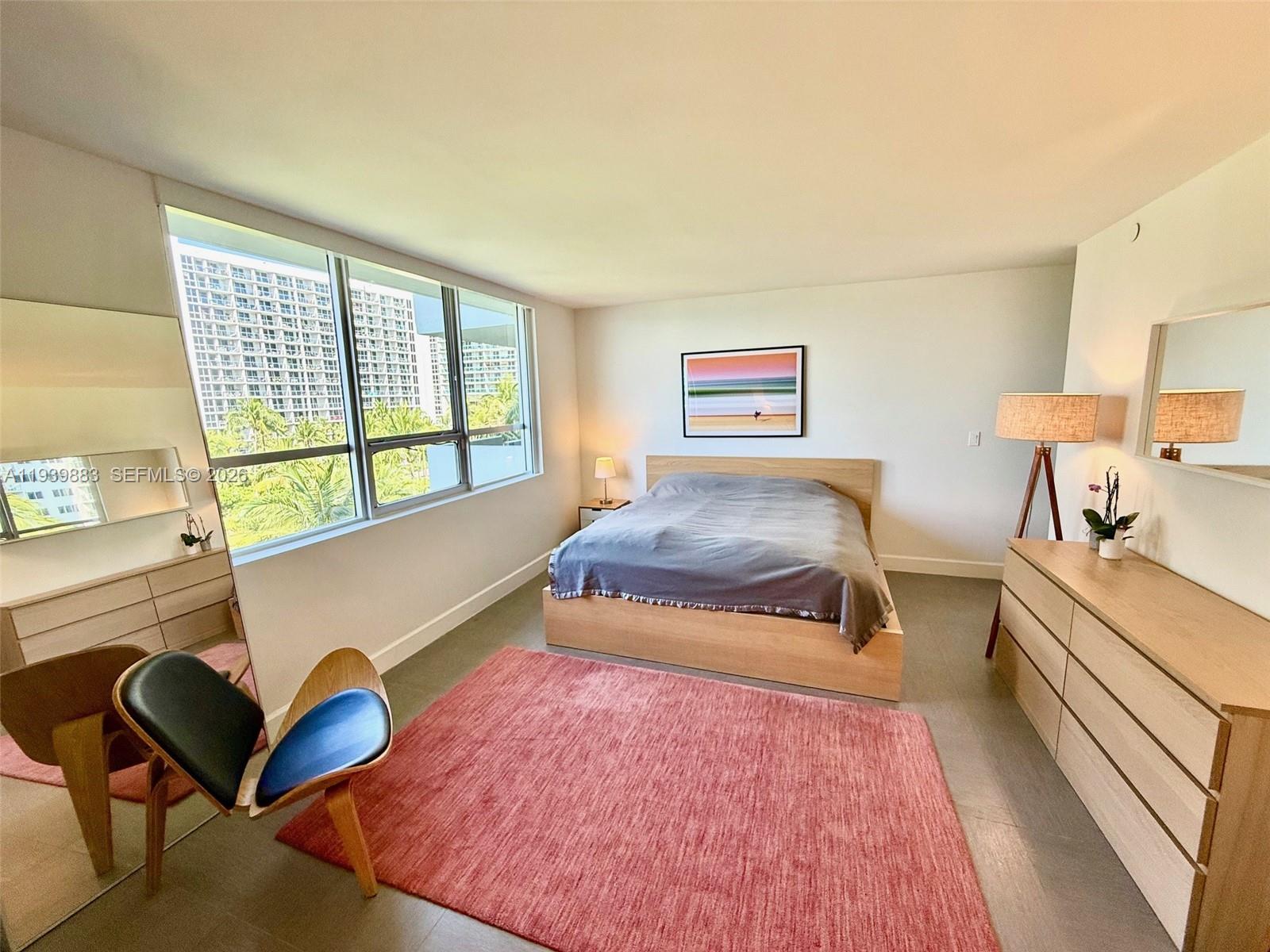 1500 Bay Road, Unit 540S Miami Beach, FL 33139 - Photo 12 of 40 a bedroom with furniture and a large window