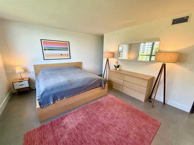 a bed room with a bed and a chair