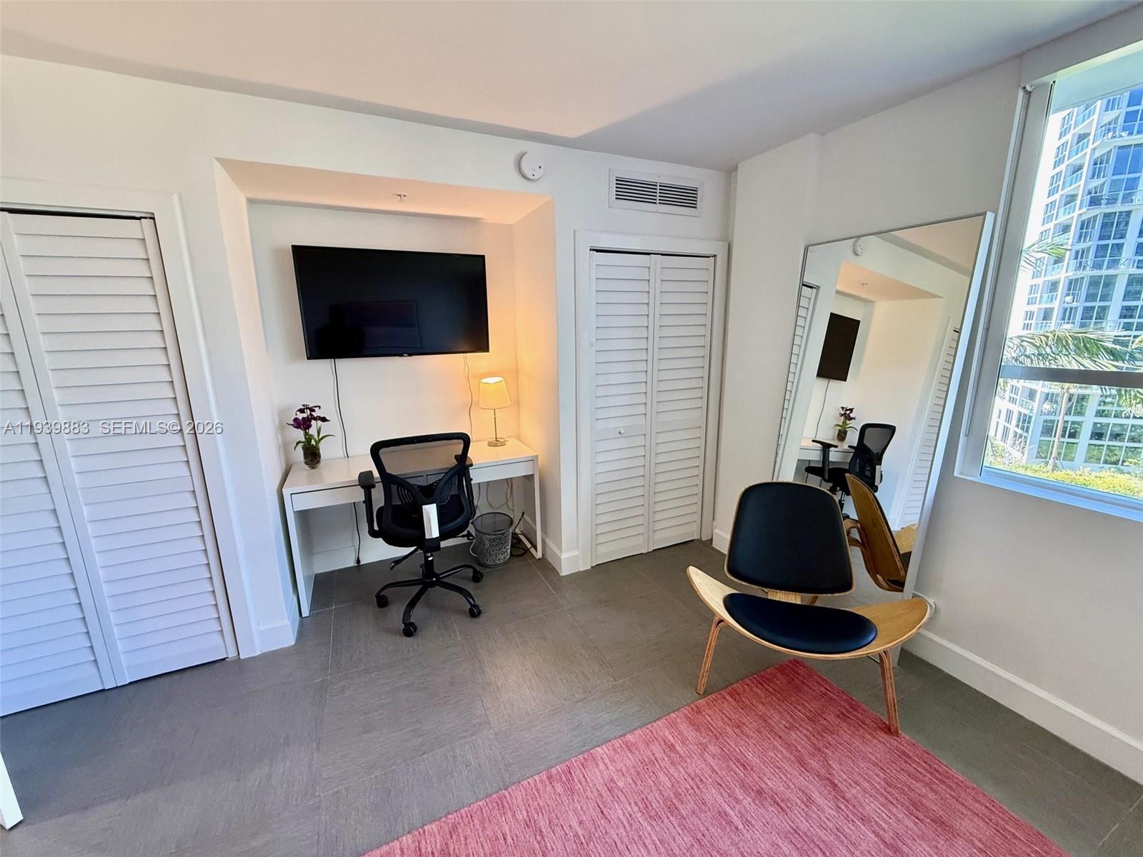 1500 Bay Road, Unit 540S Miami Beach, FL 33139 - Photo 15 of 40 a living room with furniture and a flat screen tv