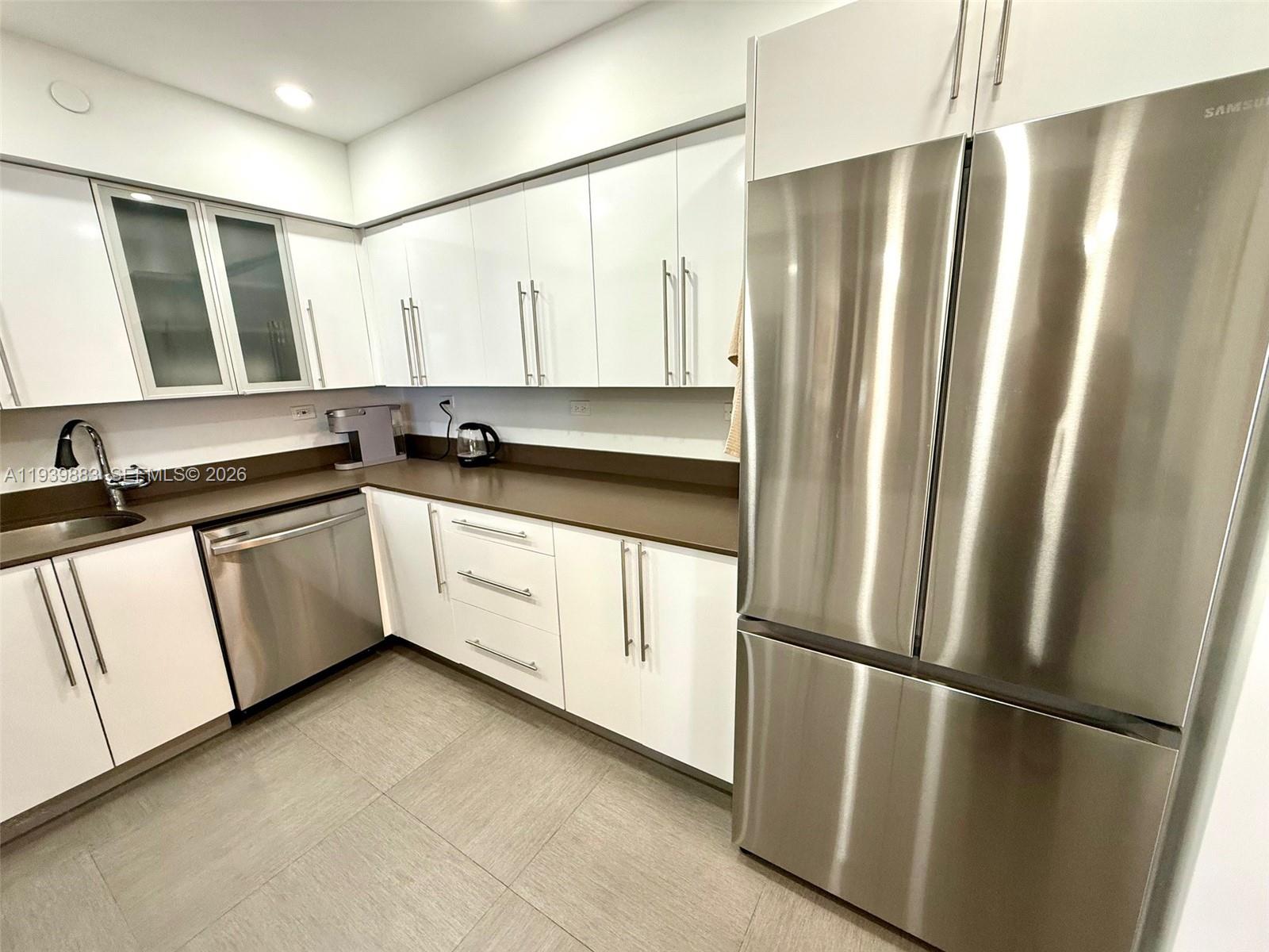1500 Bay Road, Unit 540S Miami Beach, FL 33139 - Photo 9 of 40 a kitchen with stainless steel appliances a refrigerator and a sink