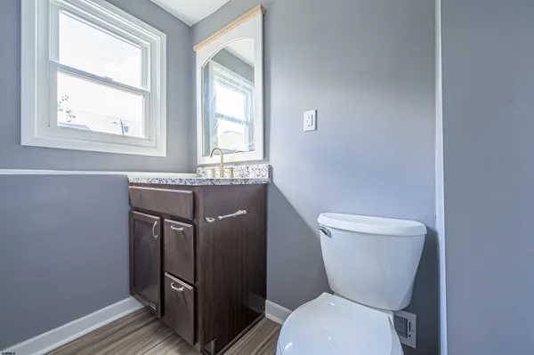 a bathroom with a toilet a sink and a window