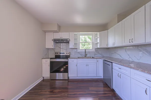 a kitchen with a sink cabinets and window