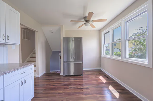 a kitchen with a refrigerator a sink and cabinets