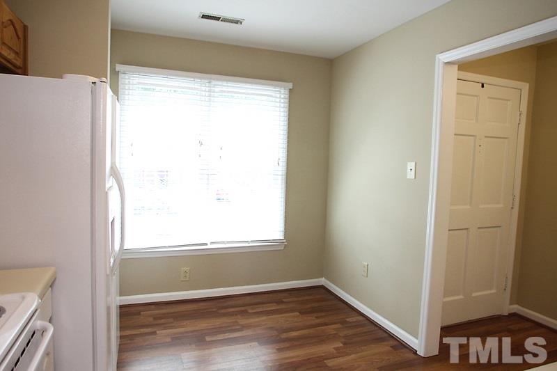 4635 Fawnbrook Circle Raleigh, NC 27612 - Photo 3 of 12 a view of an empty room with wooden floor and a window
