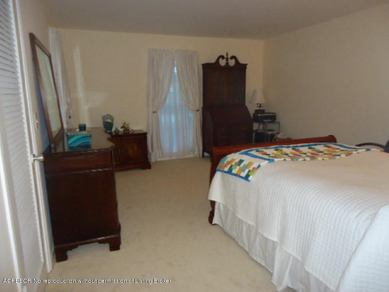 5 Little Pond Road Manalapan, FL 33462 - Photo 14 of 19 a bedroom with a bed and a dresser