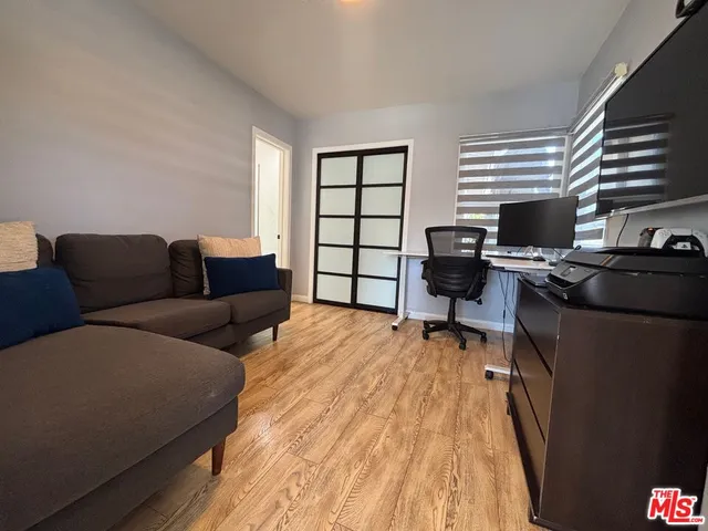 a livingroom with workspace and a couch