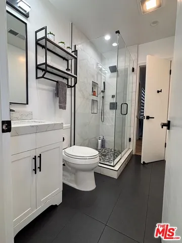 a bathroom with a toilet a sink and shower