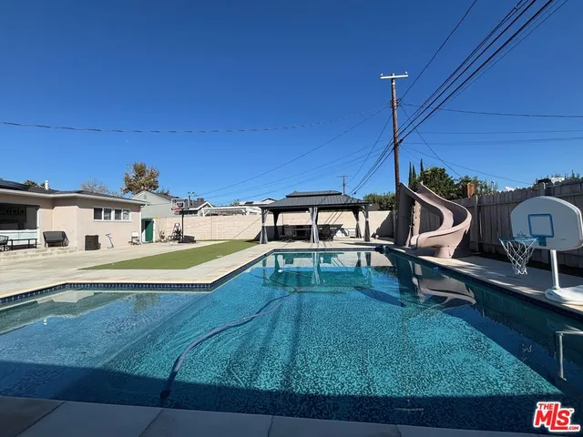 a view of a swimming pool with a yard