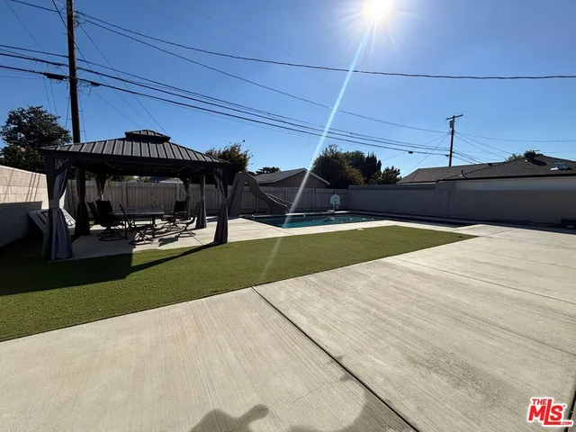 a view of a swimming pool with a yard