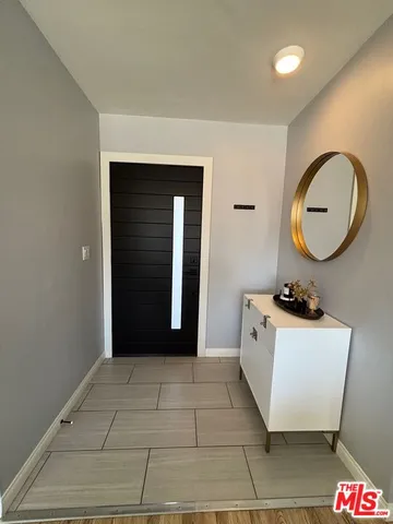 a view of a bathroom with a sink and a mirror