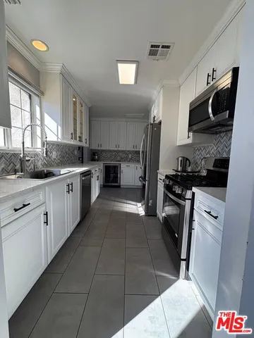 a kitchen with a sink a stove and refrigerator