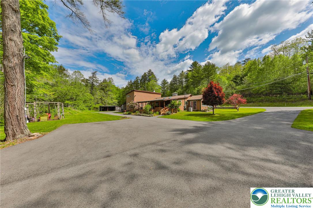 331 Cranberry Creek Road Cresco, PA 18326 - Photo 83 of 95 A verdant landscape envelops this charming residence, accessed by a broad paved driveway.