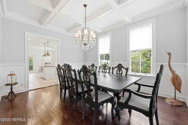 a kitchen with stainless steel appliances granite countertop a sink a stove a refrigerator and island with wooden floor