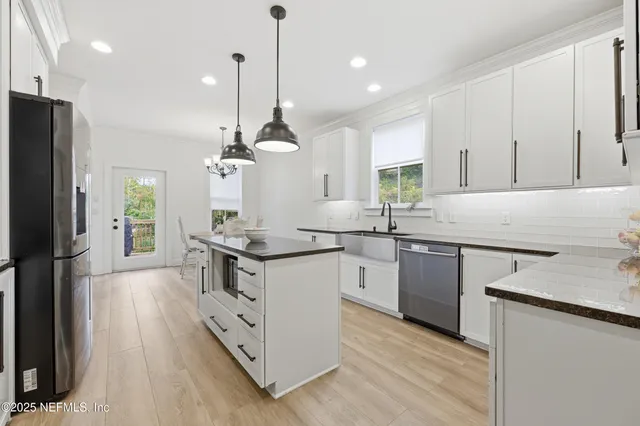 a view of a dining room with furniture wooden floor and chandelier