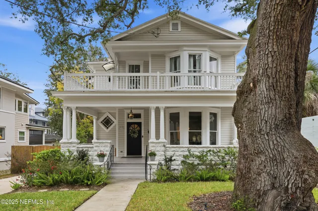 a view of a hallway with wooden floor and workspace