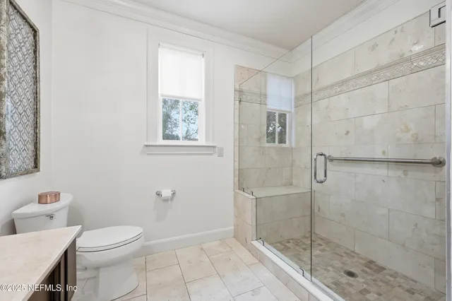 a bathroom with bathtub and window