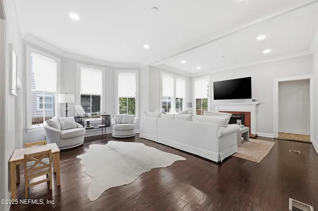 a bedroom with bed and a large window