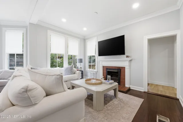 a living room with furniture and large windows