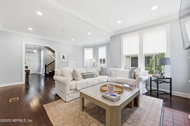 a view of a balcony with chairs and wooden fence