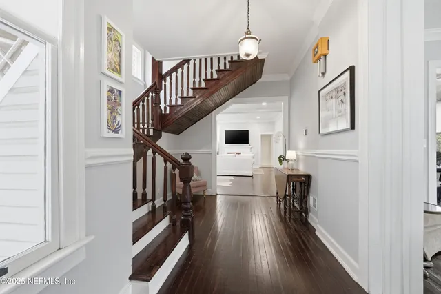 a view of a dining room with furniture wooden floor and chandelier