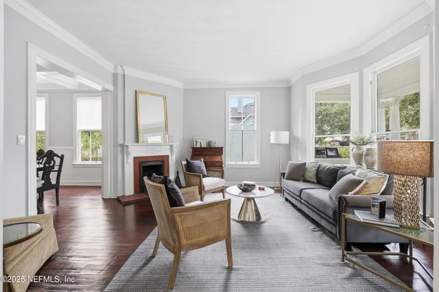 a dining room with furniture a chandelier and wooden floor
