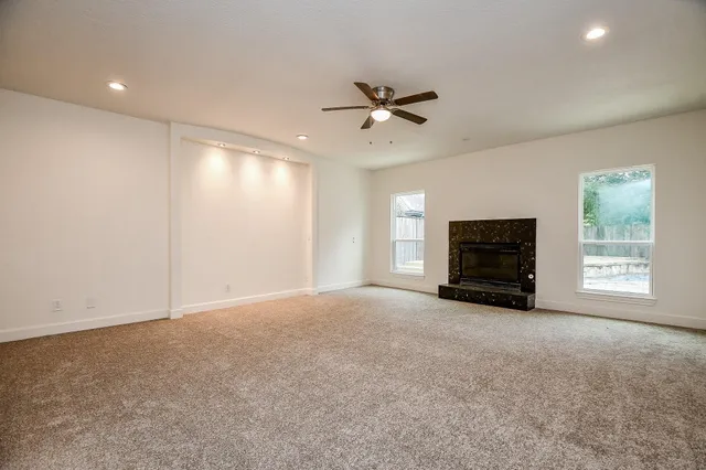 a view of empty room with a fireplace