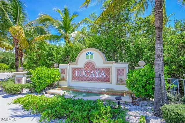 a sign that is sitting in front of flowers