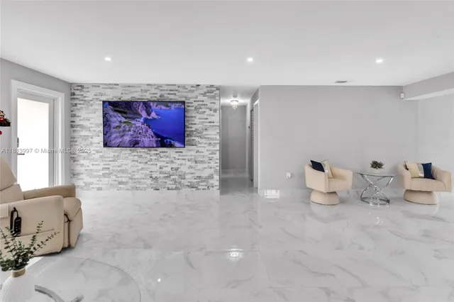 a kitchen with stainless steel appliances a refrigerator sink and chairs