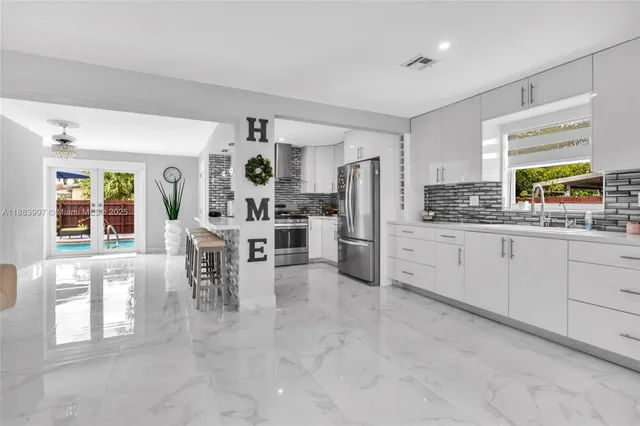 a living room with furniture and large window