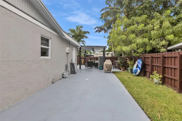 a view of a patio with table and chairs and potted plants