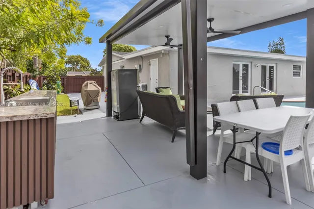 a view of a patio with a table and chairs