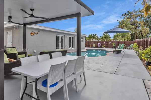 a view of pool table and chairs in back yard