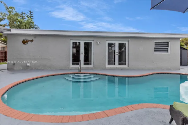 a view of a swimming pool with a patio