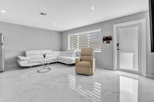 a living room with furniture and a large window