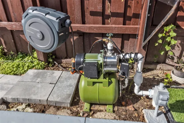 a view of a white house with a yard and palm trees
