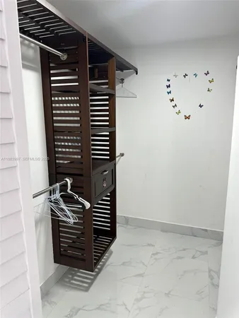 a view of a hallway with a kitchen
