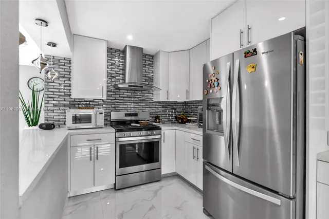 a kitchen with stainless steel appliances a refrigerator sink and stove