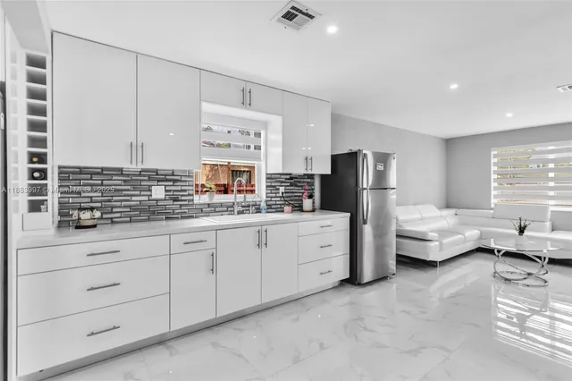 a kitchen with granite countertop a sink and dishwasher