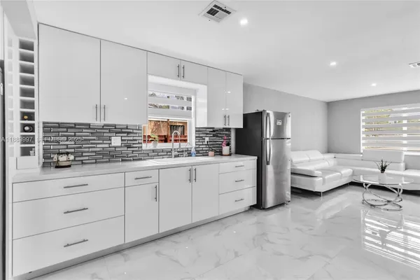 a kitchen with granite countertop a sink and dishwasher a stove top oven