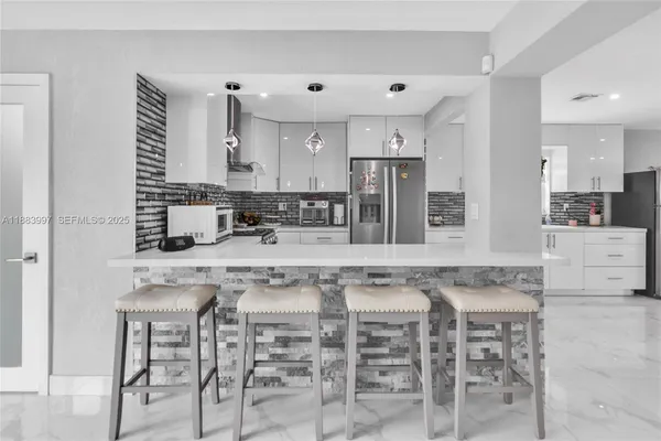 a kitchen with stainless steel appliances granite countertop a sink and cabinets