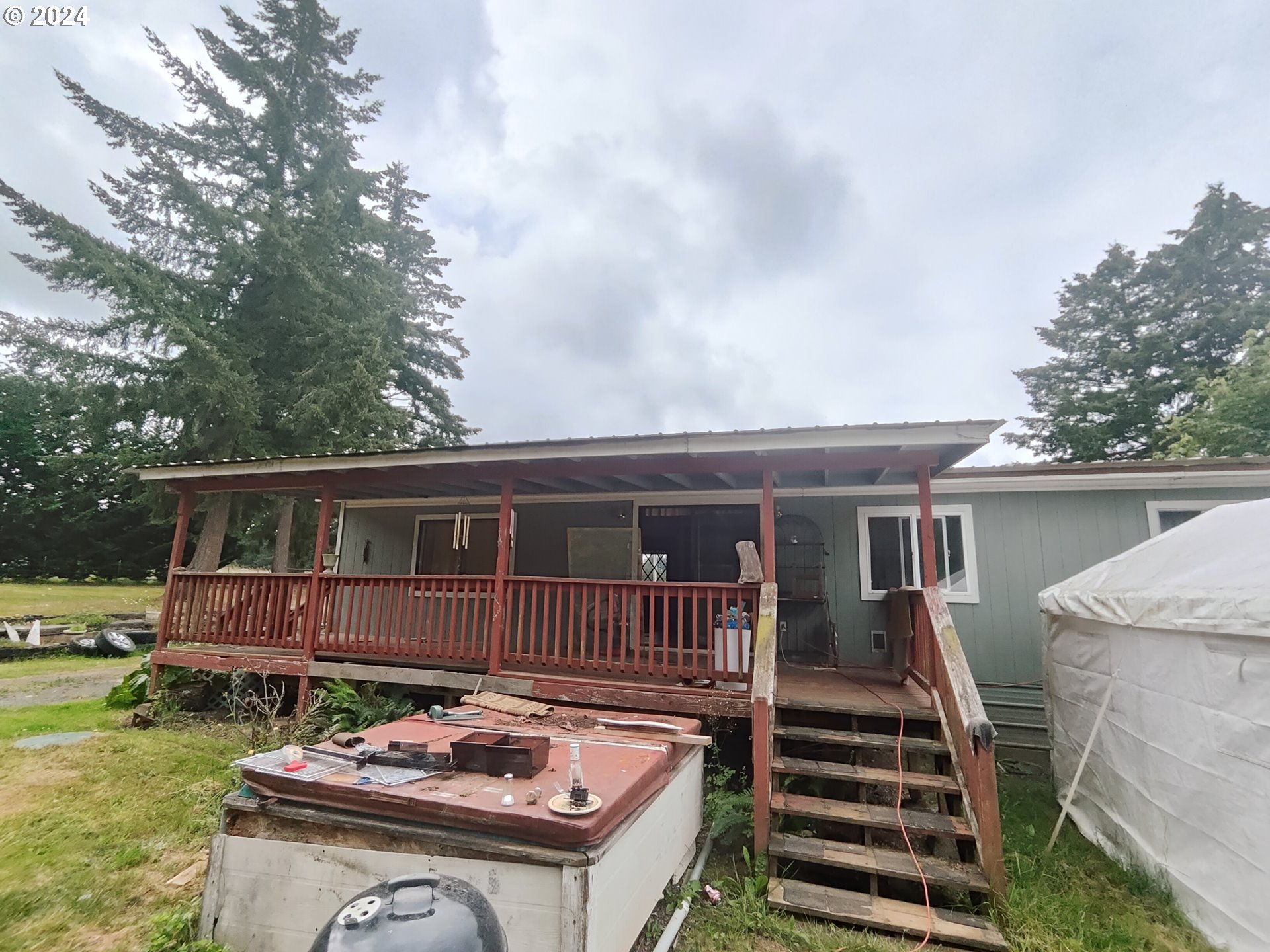 244 Bay Road Winlock, WA 98596 - Photo 4 of 29 a backyard of a house with barbeque oven and sofas