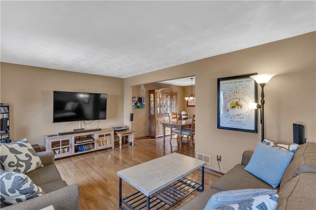 116 Rizzi Drive Irwin, PA 15642 - Photo 21 of 38 17x12 Living Room to Left of the Entry with Gleaming Wood Floors that Continue into the Dining Room.