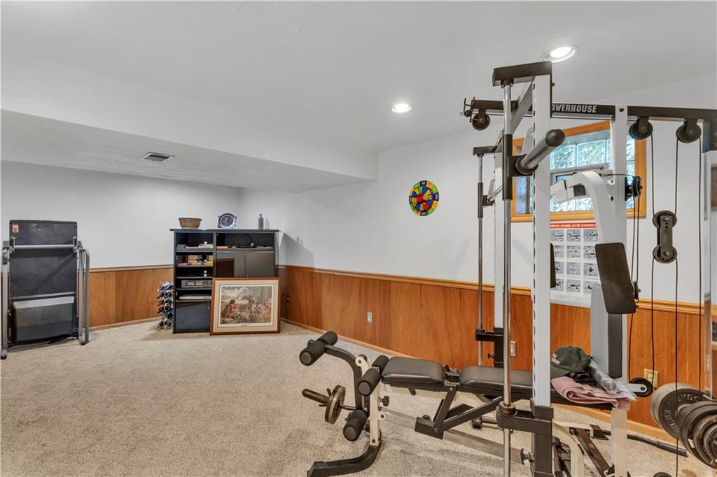 116 Rizzi Drive Irwin, PA 15642 - Photo 34 of 38 22x11 Finished Gameroom on the Lower Level with Neutral Carpet and Recessed Lighting.
