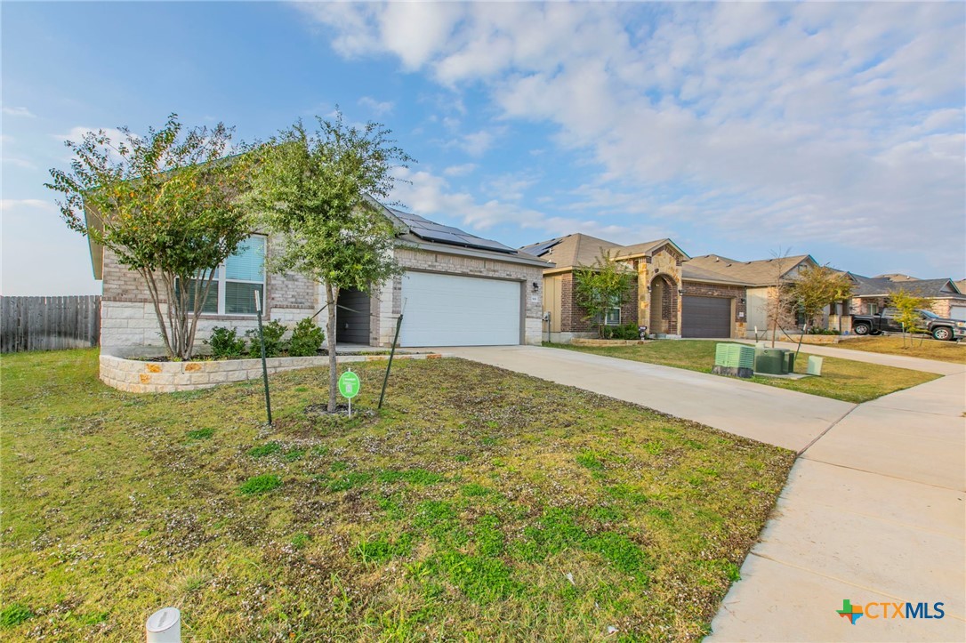 908 Coriander Road Temple, TX 76501 - Photo 22 of 28 a house view with swimming pool and trees in front of it