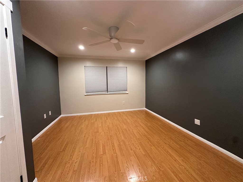 6600 Warner Avenue, Unit 210 Huntington Beach, CA 92647 - Photo 13 of 47 an empty room with wooden floor and windows