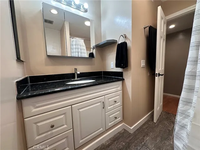 a kitchen with stainless steel appliances kitchen island granite countertop a refrigerator and a stove top oven