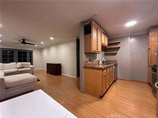 a kitchen with stainless steel appliances granite countertop a stove a sink and a refrigerator