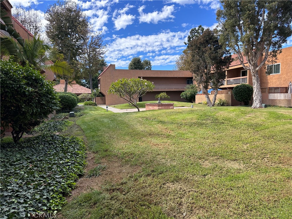 6600 Warner Avenue, Unit 210 Huntington Beach, CA 92647 - Photo 28 of 47 a view of a house with a yard