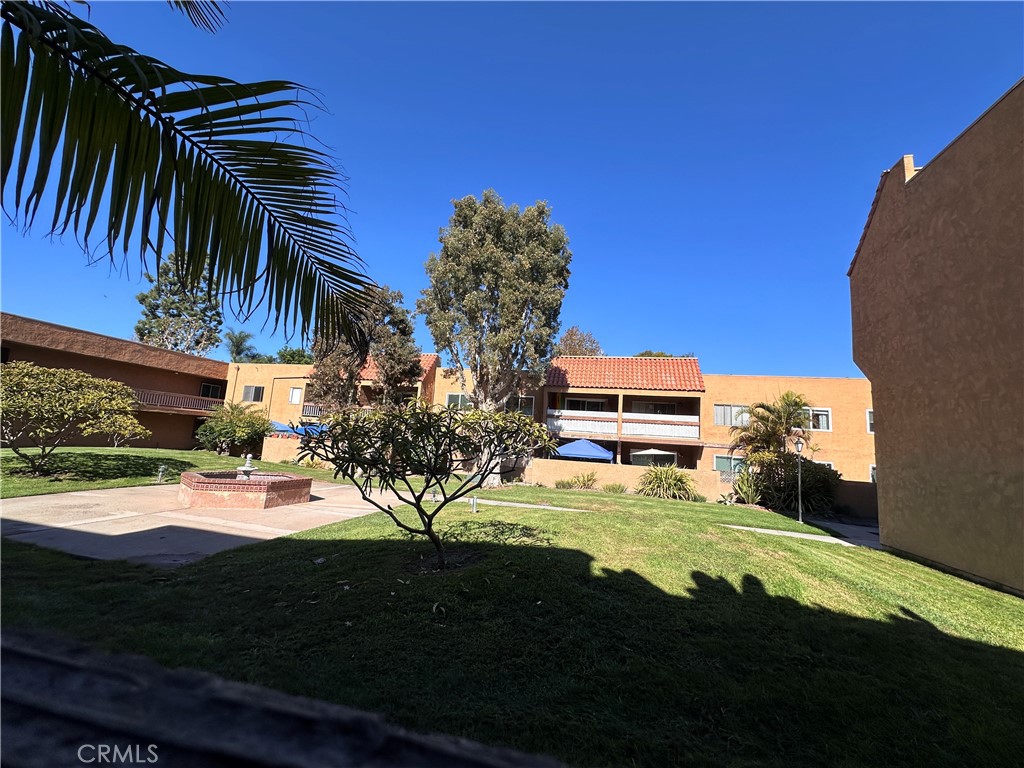 6600 Warner Avenue, Unit 210 Huntington Beach, CA 92647 - Photo 33 of 47 a view of a house with a yard